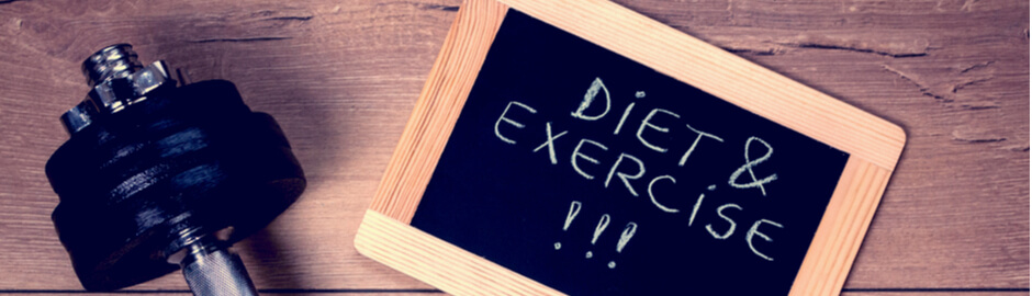 Reminder to diet and exercise on small chalkboard with dumbbell